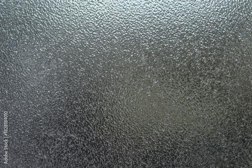 Frozen ice structure on the side window of a car in detail.
