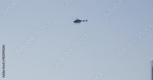 Helicopter flying past New York city skyscrapers and over bay