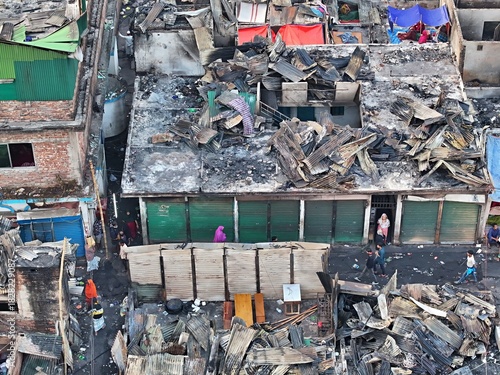 Dhaka, Bangladesh - 28 November 2025: Aerial view of a devastating fire site in Korail slum, with charred rooftops and scattered debris revealing the stark reality of urban poverty.