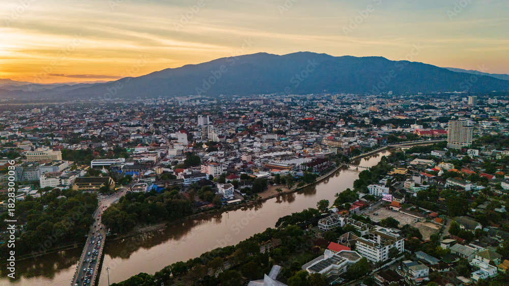 Obraz premium drone aerial sunset of Chiang Mai Thailand cityscape old town temples mountains and ping river, travel destination 
