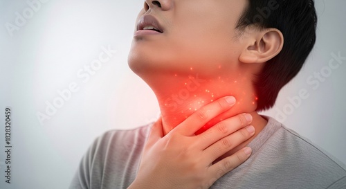 Young man suffering from painful throat inflammation or sore neck medical problem concept