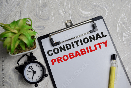 Concept of conditional probability write on clipboard isolated on Wooden Table.