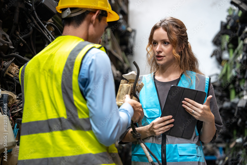 Obraz premium Portrait Caucasian woman and Asia man engineer or mechanic use tablet computer checking auto part or car part at car part warehouse