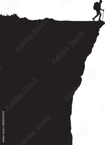 Silhouette hiker stands on cliff edge with backpack and pole
