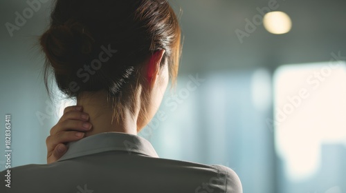 Woman touching neck back view