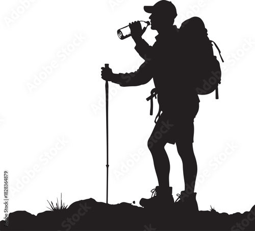 Silhouette of hiker drinking from bottle on rocky terrain