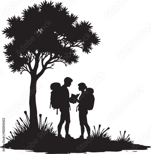Silhouette of hikers with backpacks looking at map under tree
