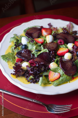 salad of eggs, meat, strawberries, raspberries