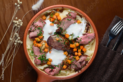 The Kazakh national dish Beshbarmak consists of boiled dough, meat and vegetables, sprinkled with sour cream.