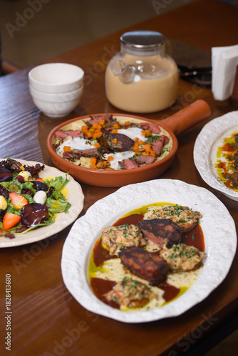 a variety of dishes on the table with milk tea