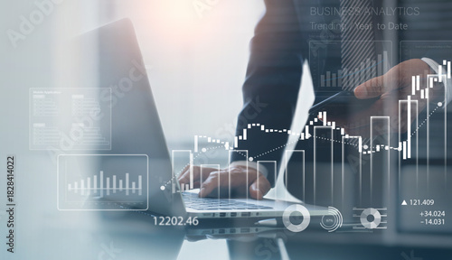 Business, finance and investment concept. Businessman using digital tablet analyzing financial data with economic graph growth chart, Business strategy and planning. market research