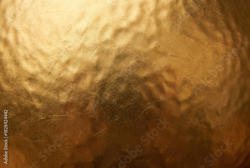 Close-up of Textured Golden Metallic Surface with Subtle Scratches image photo