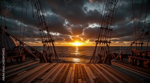 A dramatic sunset view from the deck of an old wooden sailing ship.