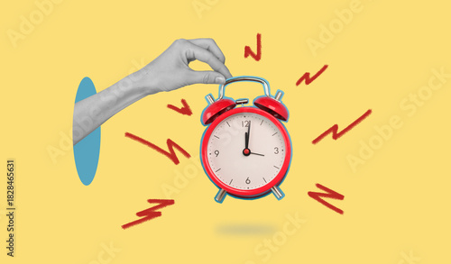 A hand holding a red alarm clock with the time of 11:30
