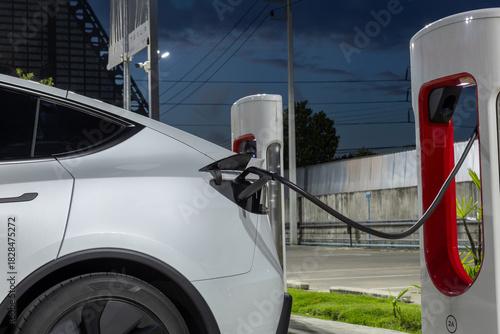 Electric car charging station. Hybrid car Electric charger station in the Car Park. Electric car charging on parking and charging station. Electric socket. Transportation EV