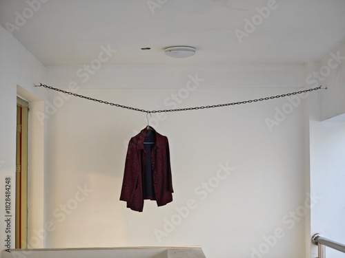 a close-up view of a black jacket hanging on the clothes line