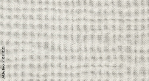 Neutral light beige linen fabric texture. High-resolution top view detailing the rough, woven fiber pattern and grainy surface.