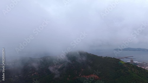 Epic sea of clouds flowing over coastal mountains and ocean at dawn, China