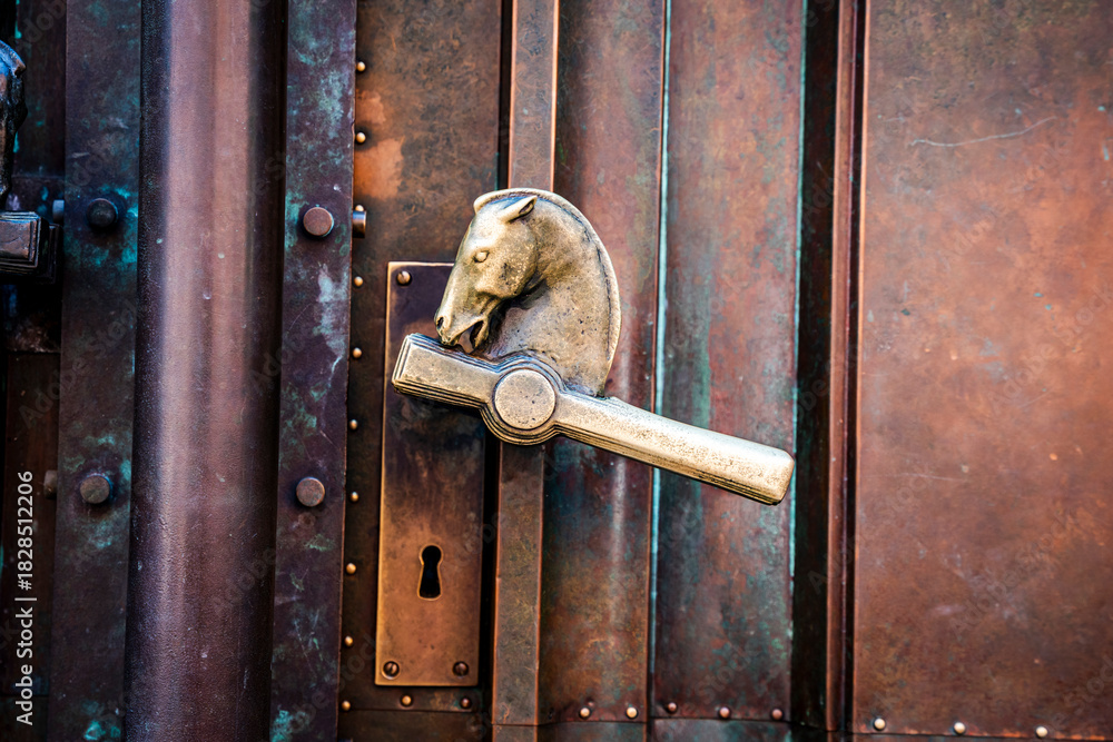 Fototapeta premium Door handles in the shape of a horse's head at the entrance of the National and University Library of Slovenia, designed by Joze Plecnik on Turjaska Street, Ljubljana, Slovenia