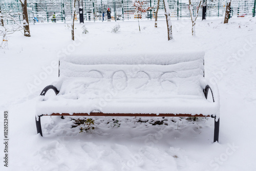 Wallpaper Mural A bench in a winter park is covered with a thick layer of snow, with the number “2026” playfully written on the surface. The scene evokes festive anticipation, seasonal calm, and holiday atmosphere. Torontodigital.ca