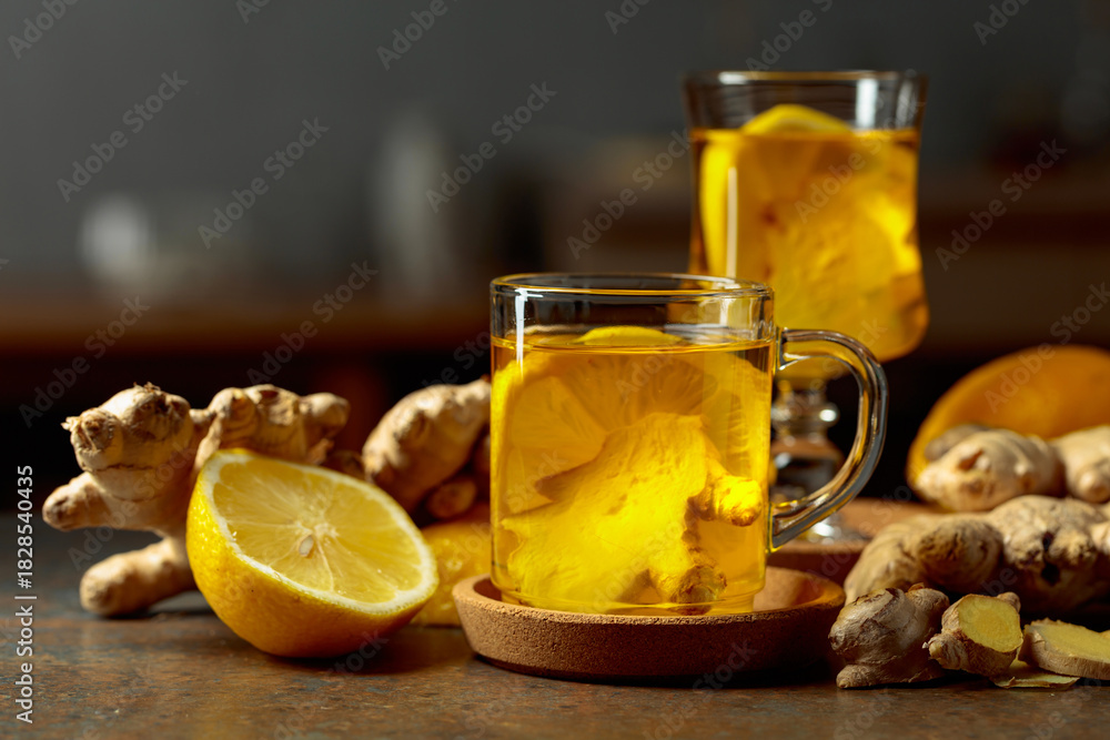 Fototapeta premium Ginger tea with lemon on a kitchen table.