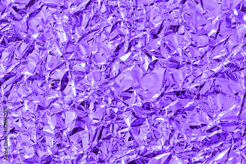 Shiny metal purple foil leaf crumpled texture background.
