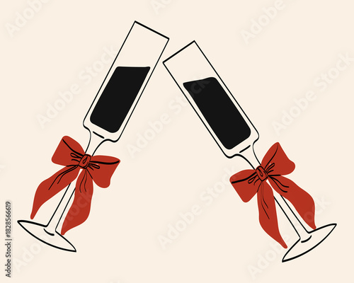 Two champagne flutes with red bows clink together in celebration, perfect for a festive event or special occasion outside