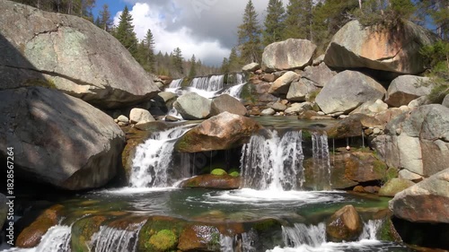 Small waterfalls flowing among the rocks in the mountains