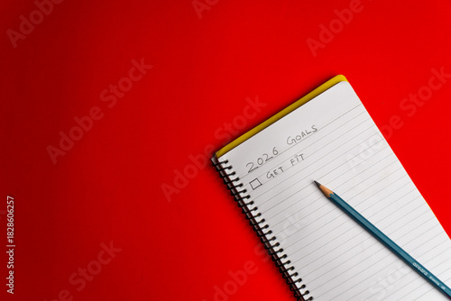 2026 goals list with push pins, an indoor plant and a sticky note on red background. Creative New Year planning and resolution, goals, action, checklist, expectations concept. New Year 2026 card 