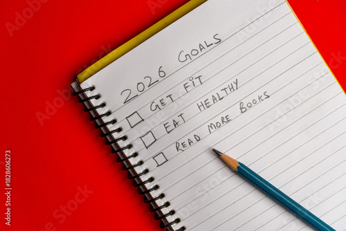 2026 goals list with push pins, an indoor plant and a sticky note on red background. Creative New Year planning and resolution, goals, action, checklist, expectations concept. New Year 2026 card 