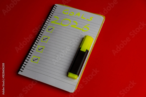 2026 goals list with push pins, an indoor plant and a sticky note on red background. Creative New Year planning and resolution, goals, action, checklist, expectations concept. New Year 2026 card 