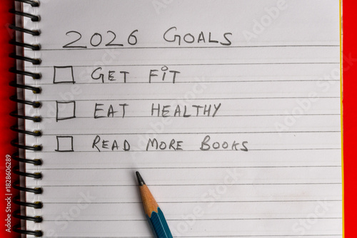 2026 goals list with push pins, an indoor plant and a sticky note on red background. Creative New Year planning and resolution, goals, action, checklist, expectations concept. New Year 2026 card 