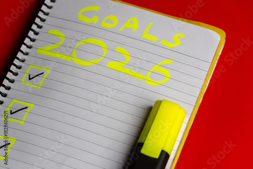 2026 goals list with push pins, an indoor plant and a sticky note on red background. Creative New Year planning and resolution, goals, action, checklist, expectations concept. New Year 2026 card 