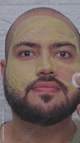 Vertical Video of Man Removing Clay Mask From Face