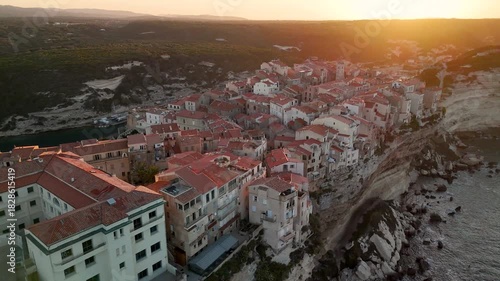 Cinematic Aerial Drone Pan Shot Over the Historic City of Bonifacio Perched on Dramatic Limestone Cliffs at Sunrise, Corsica, France.
