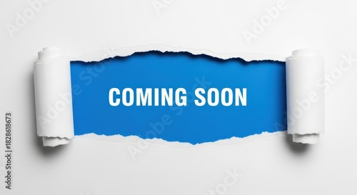 Coming soon message revealed by ripped white paper, isolated on white background