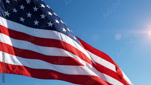 Vibrant American flag proudly waving against a brilliant blue sky, illuminated by warm sunlight, symbolizing national pride, freedom, and liberty
