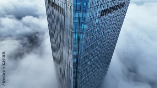 Skyscraper Piercing Through Clouds - A Modern Architectural Marvel.
