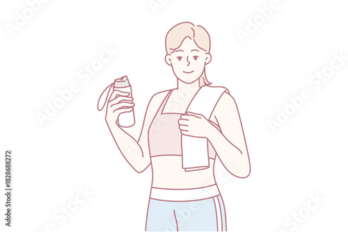 barista holding takeout cup and smartphone while wearing apron, offering drink with welcoming smile.