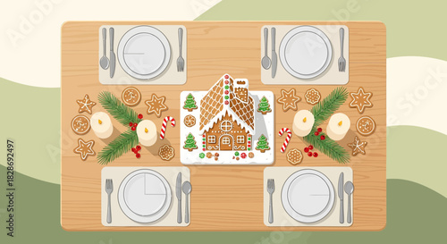 Festive holiday gingerbread house dinner table setting with sweet treats and candles