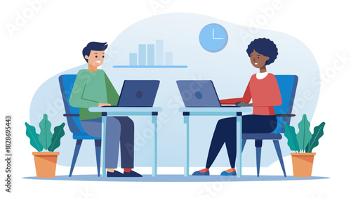 Diverse colleagues working together on laptops at desks in a modern office environment