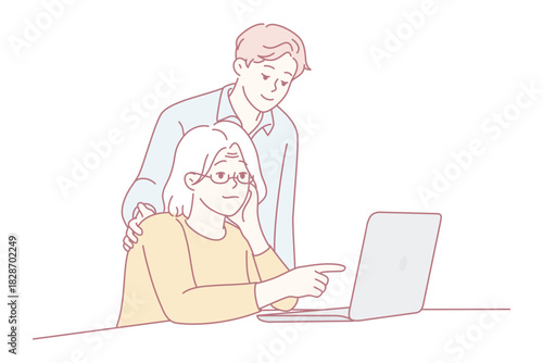older woman using laptop with colleague leaning over shoulder offering guidance, calm office setting, hands