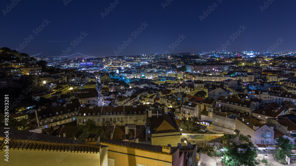 Fototapeta premium Lisbon panorama after sunset aerial view of city centre with red roofs at autumn day to night timelapse, Portugal