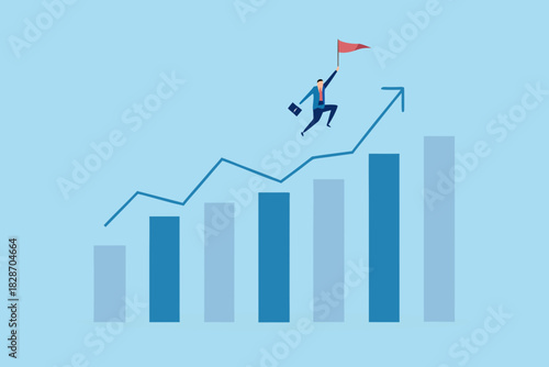 Businessman conquering growth chart and holding flag business success concept