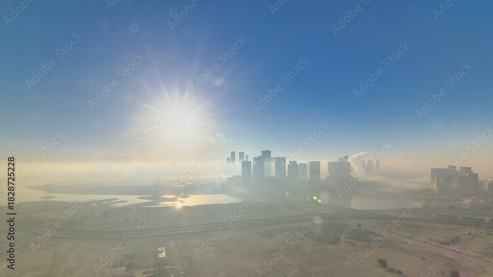 Naklejka premium Abu Dhabi city skyline with skyscrapers at sunrise from above timelapse