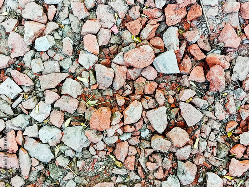 A close up view of broken bricks and small rocks on ground