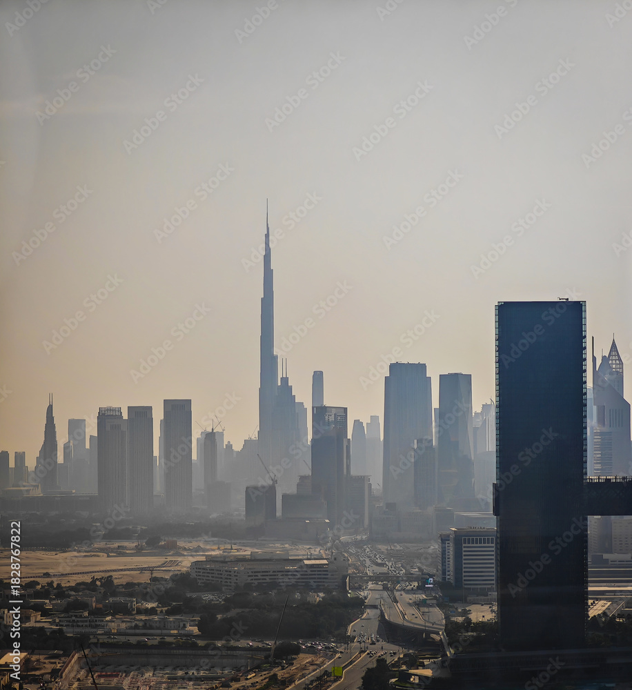 Naklejka premium Dubai Downtown and Business bay in the distance. Aerial drone view of Dubai panorama in dusk and sandstorm dust