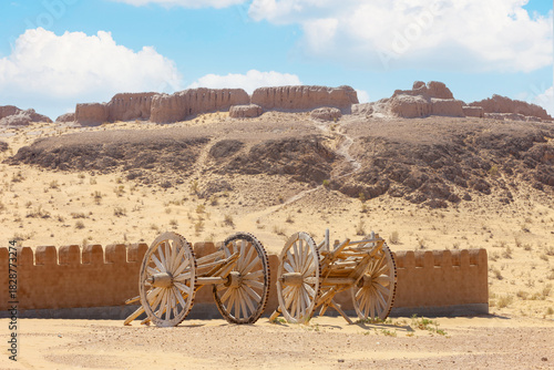 Kyzylkum Desert, Uzbekistan, foreshortening of Ayaz Kala (Wind fortress) complex with old abandoned wooden farm carts