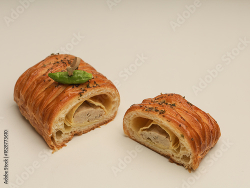 Danish pastry with savory filling on white background