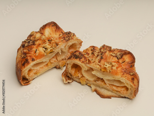 Danish pastry with savory filling on white background